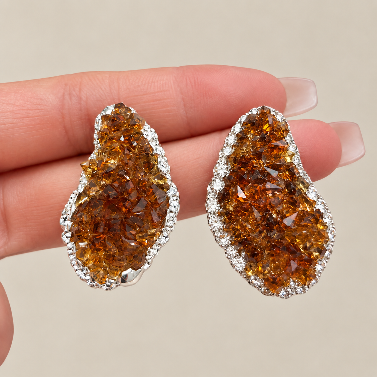 Close-up of brown crystal stud earrings held in hand