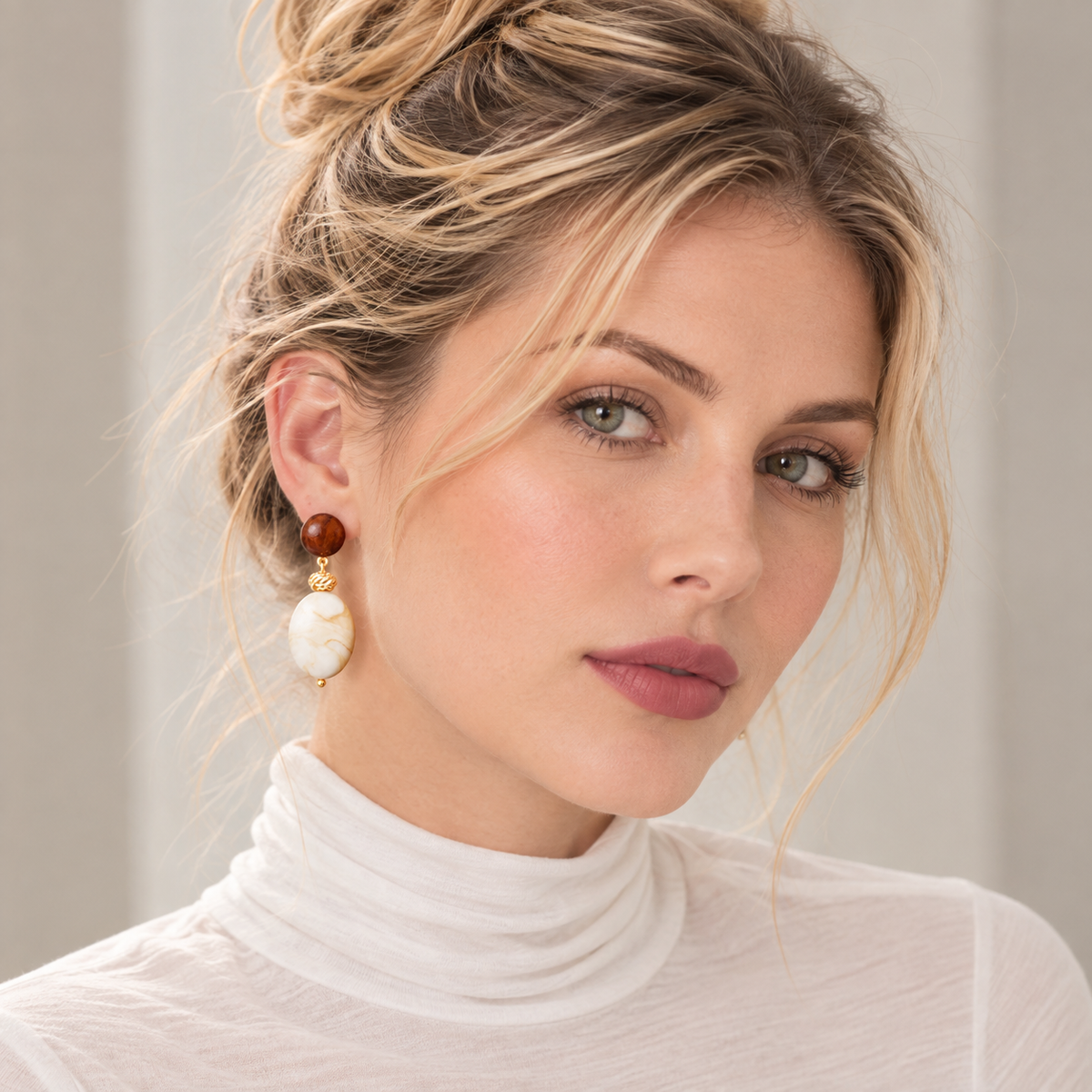 Brown and ivory drop stud earrings worn on ear