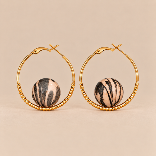 Gold beaded hoop earrings with black and ivory-tone striped round accents