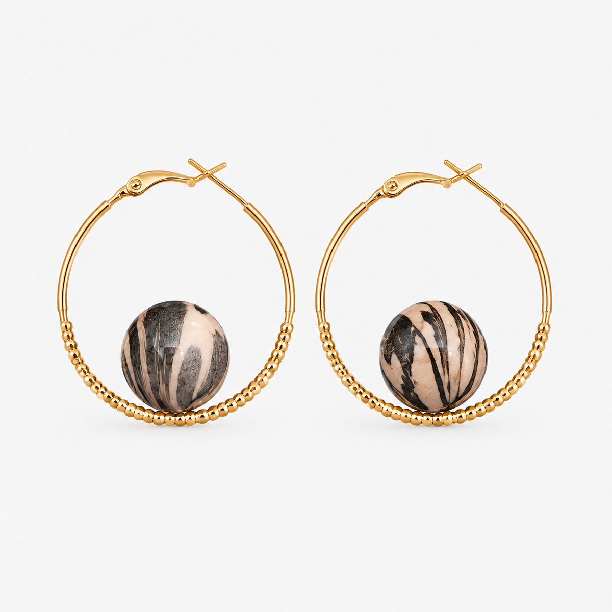 Gold beaded hoop earrings with black and ivory-tone striped round accents