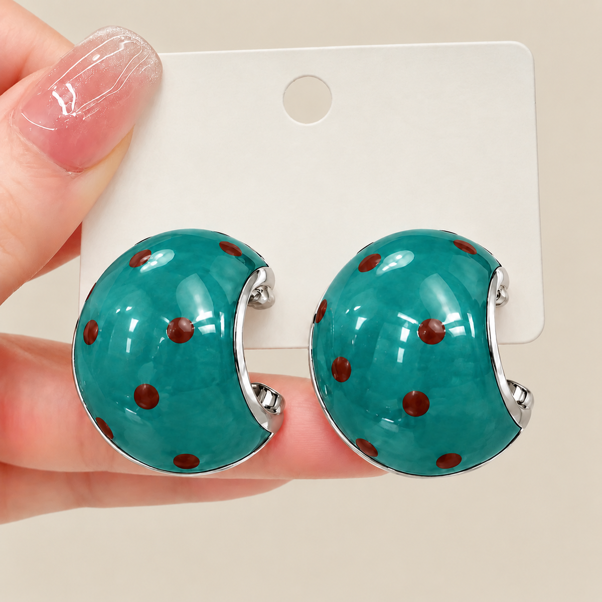 Green polka dot chunky hoop earrings displayed on jewelry card