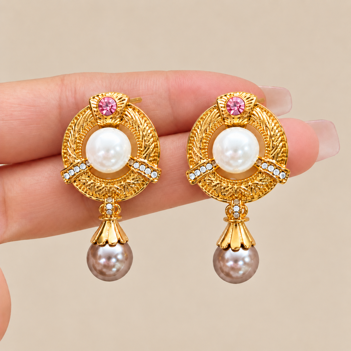 Vintage gold pearl drop earrings shown in hand